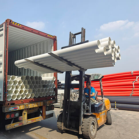 Forklift handling white rigid PVC pipes beside a shipping container at the Puhui factory